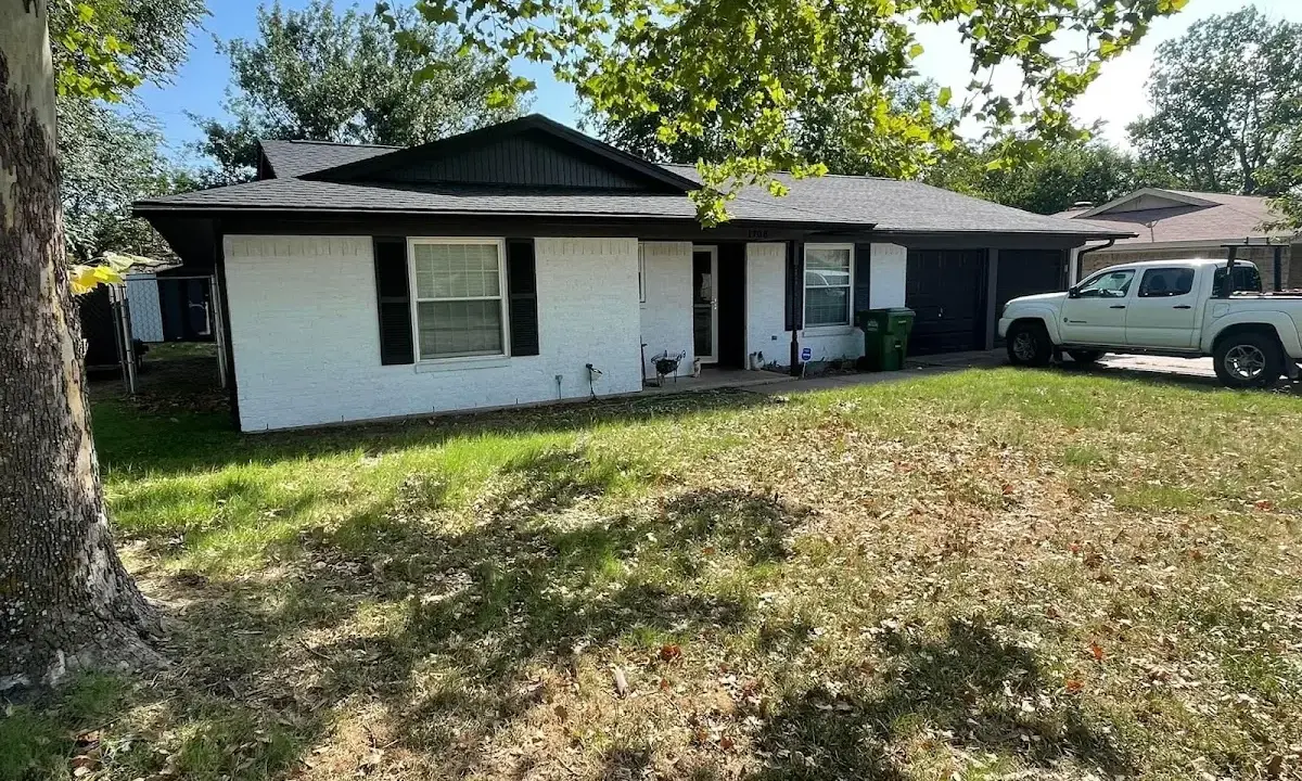 Professional roofing crew working on a residential roof in Becker